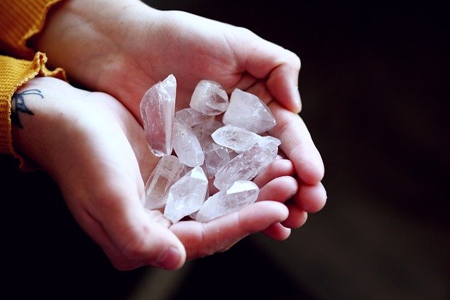 Hands cupping white cloudy crystals